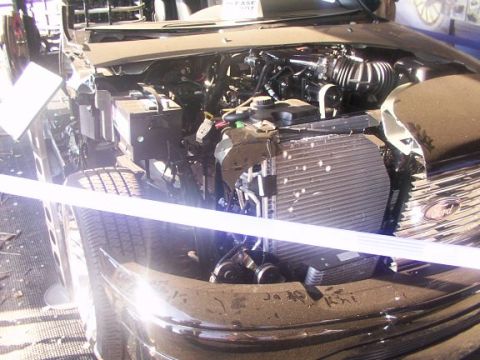 1998 Ford Taurus - The engine bay of a 1998 Ford Taurus is visible, showing the radiator and various engine parts.