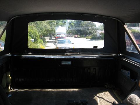 1989 Ford Bronco - View looking rearward from inside a full-size Bronco's cargo area, over the black-painted tailgate with the liftgate glass raised out of th…