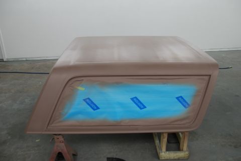 1996 Ford Bronco - A car roof section is prepped for body repair, with blue masking tape covering the window area.