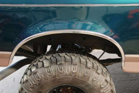 1996 Ford Bronco - Rear wheel well and tire detail of a 1996 Ford Bronco.