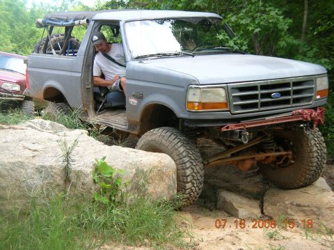1991 Ford F-150 - This 1991 Ford F-150 is shown off-roading over rocks, with another vehicle in the background.