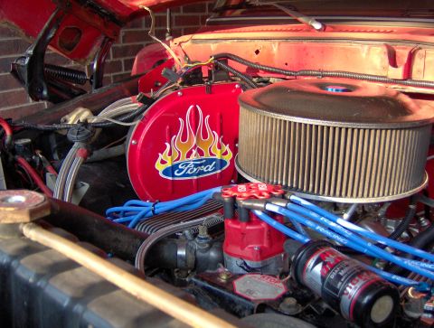 1978 Ford Bronco - Close-up of a Ford engine bay, a red valve cover with flame decals and a prominent air filter.