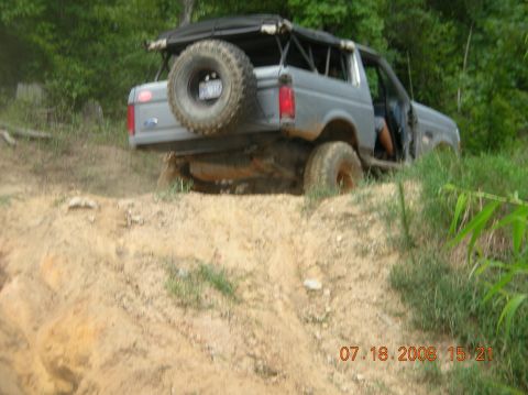 1991 Ford F-150 - This SUV appears to be a 1992 Ford Bronco, not a 1991 F-150, as it navigates an off-road trail.