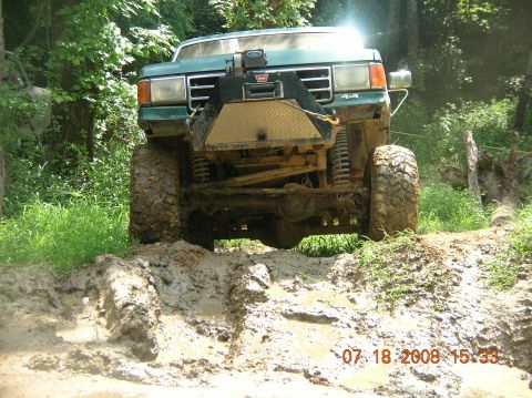 1991 Ford F-150 - This lifted 1991 Ford F-150 navigates a challenging muddy off-road course.