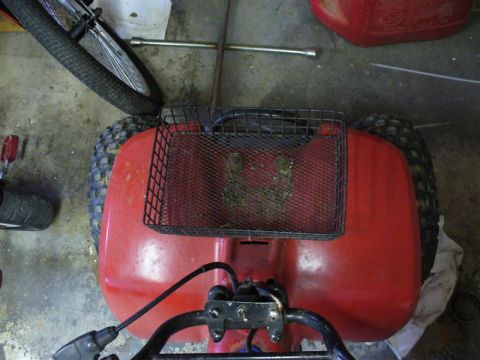 1988 Ford Bronco - This red ATV is viewed from above, showing its rear fender, basket, and a lug wrench nearby.