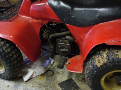 1988 Ford Bronco - Close-up of a red ATV's engine, showing the SUZUKI brand on the casing.