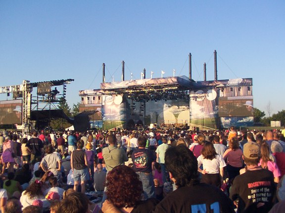 Outdoor concert stage with a large crowd gathered in front