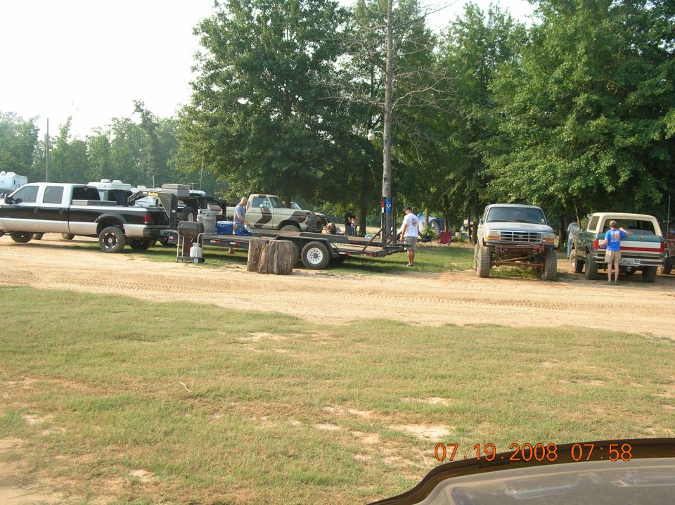 Silver Ford F-Series truck, lifted, with off-road tires, viewed from the front