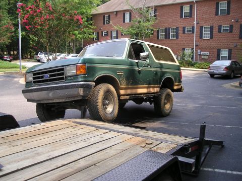 1989 Ford Bronco - Green 1989 Ford Bronco is being loaded onto a trailer.