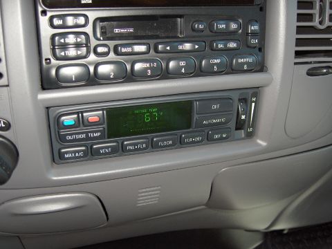 2007 Ford Mustang - The photo shows the interior of a vehicle, focusing on the radio and climate control panel.