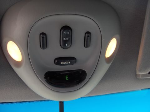 2007 Ford Mustang - The overhead console features interior lights, a sunroof control, and a digital display.