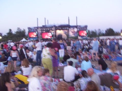 1998 Ford Taurus - A large crowd watches a performance on a stage with large video screens in the background.