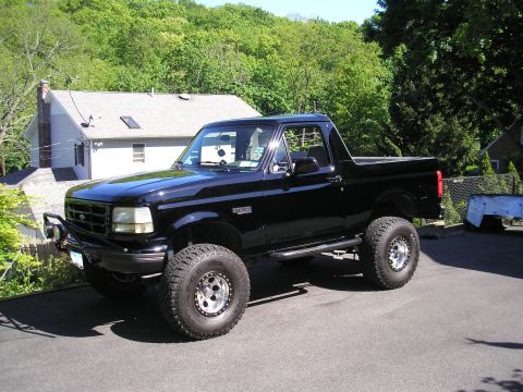 1995 Ford Bronco - This black 1995 Ford Bronco features off-road modifications and aftermarket wheels.
