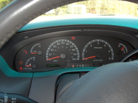 2007 Ford Mustang - The vehicle's interior shows the dashboard gauges and steering wheel, with the odometer displaying 051677.