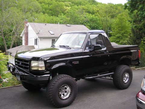 1995 Ford Bronco - This black Ford Bronco is shown from a three-quarter front angle, modified with off-road accessories.