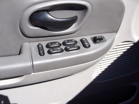 2007 Ford Mustang - Close-up of a car's interior door panel, showing the window and lock controls.