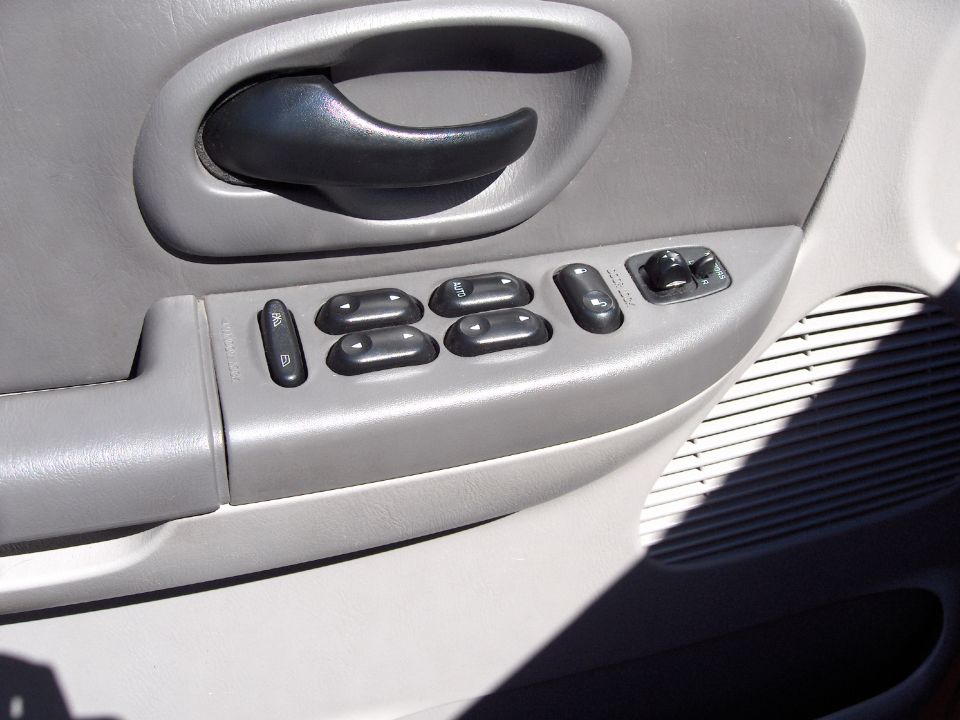 Interior door panel with window and lock controls