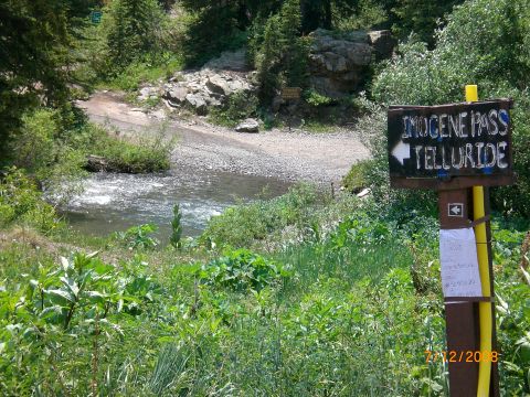 2004 Ford F-150 - Signpost indicates Imogene Pass and Telluride, with a river flowing nearby in a natural landscape.