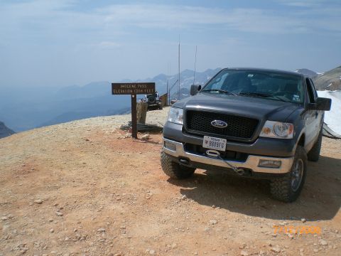 2004 Ford F-150 - A 2004 Ford F-150 truck is parked at a scenic overlook with mountains in the distance.