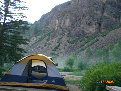 2004 Ford F-150 - A 2004 Ford F-150 is parked near a campsite with a tent in the foreground and a mountain in the background.