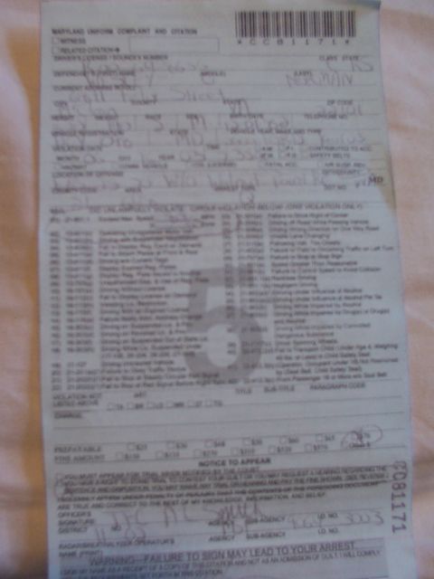 1998 Ford Taurus - A traffic citation document is shown, with various fields filled in by hand.
