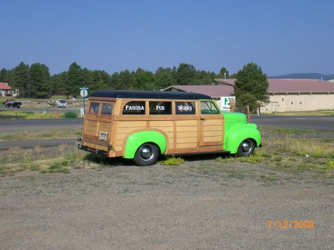 2004 Ford F-150 - This custom woodie wagon features bright green fenders and "Pagosa Pub Works" lettering on its windows.