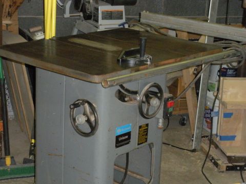 1995 Ford Bronco - A Unisaw table saw is shown in a workshop setting with various tools and materials in the background.