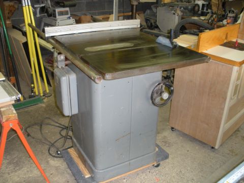 1995 Ford Bronco - A gray table saw is shown in a workshop, with various tools and equipment in the background.