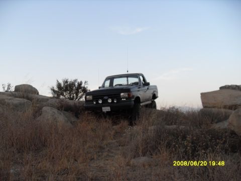 1990 Ford Bronco - This 1990 Ford Bronco navigates a challenging rocky path, its off-road capabilities.