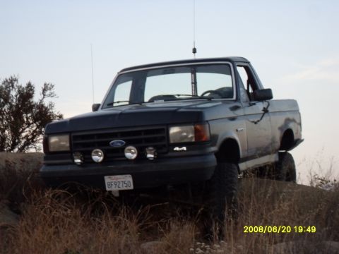 1990 Ford Bronco - 1990 Ford Bronco seen off-roading on a rocky incline.