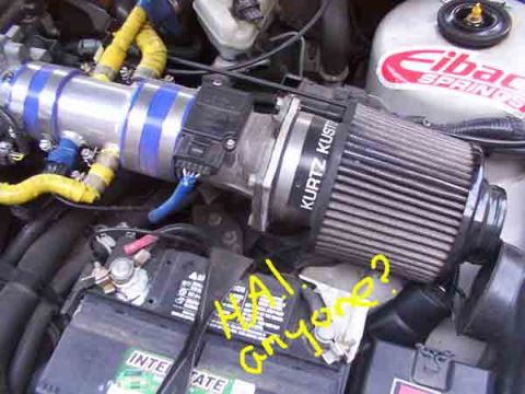 1998 Ford Taurus - Aftermarket air intake system installed in the engine bay, a Kurtz Kustom filter and an Interstate battery.
