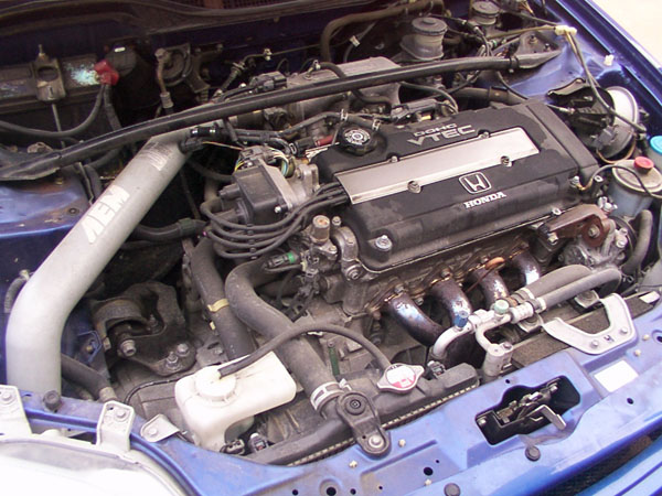Honda engine bay showing VTEC cover and AEM intake pipe