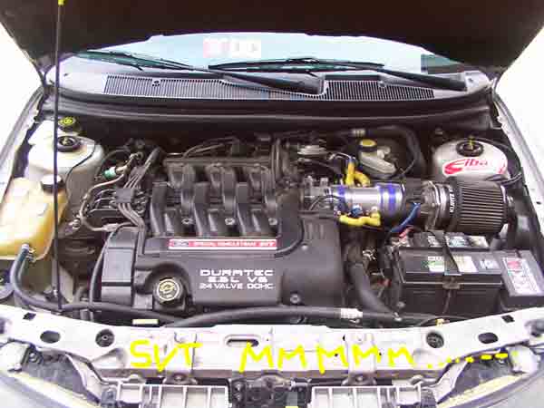 Engine bay with Duratec 2.5L V6 24 valve DOHC engine, aftermarket air intake, and battery