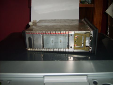 1993 Ford Crown Victoria - This is a close-up, high-angle shot of a car stereo head unit, likely from a 1993 Ford Crown Victoria, resting on a black surface.