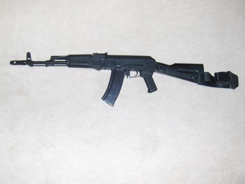 2003 Ford Crown Victoria - A firearm resembling an AK-47 is shown against a plain white backdrop.
