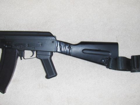 2003 Ford Crown Victoria - A close-up view of an assault rifle's stock and magazine, partially, its receiver and magazine.