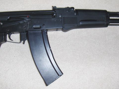 2003 Ford Crown Victoria - Close-up of an airsoft rifle, showing the receiver and magazine.