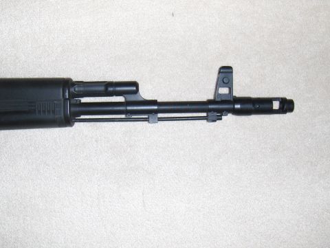 2003 Ford Crown Victoria - Close-up of an AK-47 rifle barrel, showing the front sight and muzzle device.
