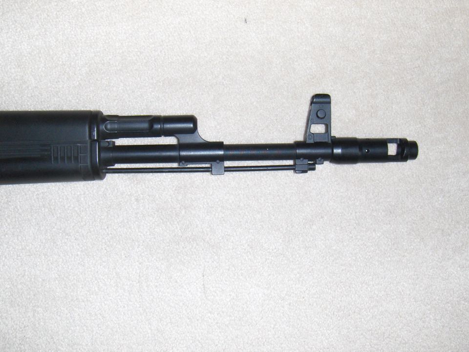 Black AK-47 rifle barrel with front sight and muzzle brake