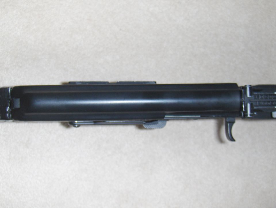 Black firearm receiver with trigger mechanism visible