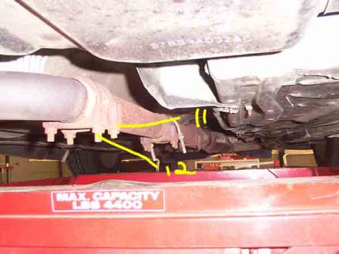 1998 Ford Taurus - Underside view of vehicle exhaust system components on a car lift.
