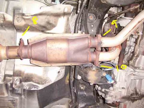 1998 Ford Taurus - This image shows the underside of a vehicle's exhaust system, including the catalytic converter and associated piping, with yellow markings…