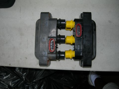 1992 Ford Taurus - This ignition coil pack features three yellow connectors and red-trimmed electrical plugs, with visible part number '0812D'.