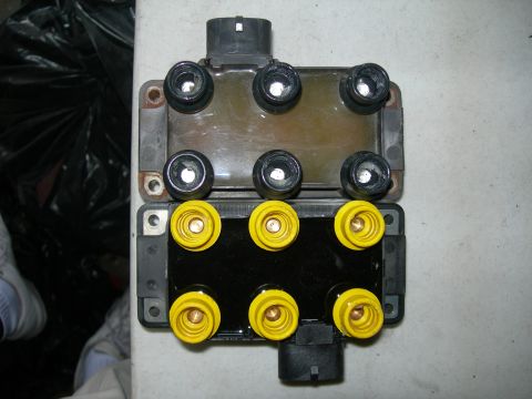 1992 Ford Taurus - Comparison of two ignition coils, one with black connectors and one with yellow connectors.