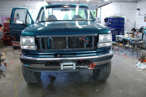 1996 Ford Bronco - Front view of a teal 1996 Ford Bronco, an aftermarket winch mounted on the bumper.