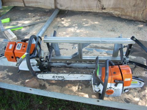2000 Chevrolet Tahoe - Two Stihl chainsaws are set up on a portable sawmill attachment.