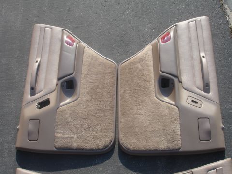 1993 Ford Taurus - A pair of car door panels are laid out on a dark, textured surface.