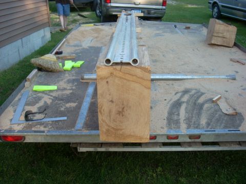 2000 Chevrolet Tahoe - A trailer is set up with lumber and equipment, with two trucks parked nearby.