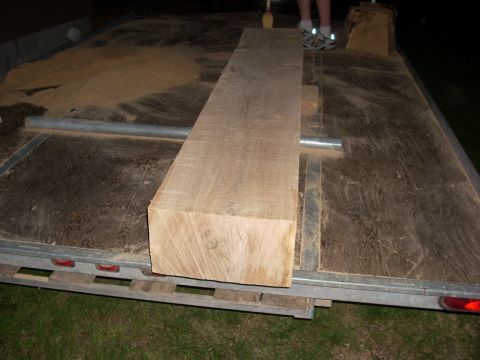 2000 Chevrolet Tahoe - Trailer loaded with lumber and sawdust, with two individuals standing in the background.