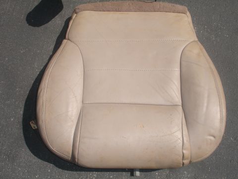 1993 Ford Taurus - A single tan leather car seat is shown from above, resting on a dark surface.